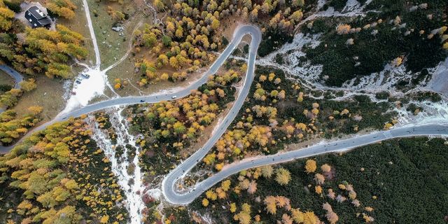 Acsi Camping low season: drone shot of street in the Dolomites in fall