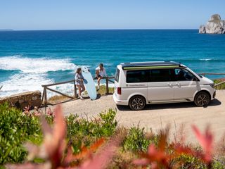 Two girlfriends on the road with the VW T6.1 California Ocean on the Portuguese coast surfing.
