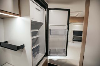 Spacious refrigerator in Mooveo travel van by CamperBoys.