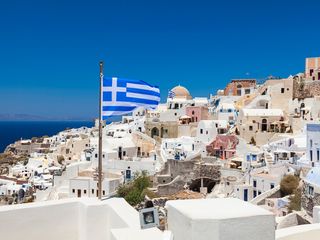 Greece flag among white houses