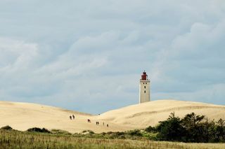 Lighthouse surrounded by dunes