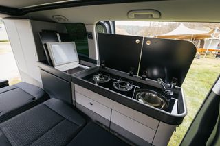Pössl Campstar interior: Kitchenette with two-burner gas stove, sink and refrigerator